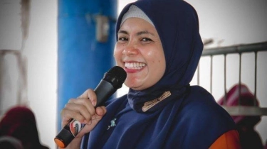Hj. Suhartina Bohari, S.E., M.I.Kom.
